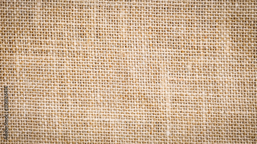Cotton woven fabric background with flecks of varying colors of beige and brown. with copy space. office desk concept, Jute hessian sackcloth natura / Hessian sackcloth burlap woven texture background