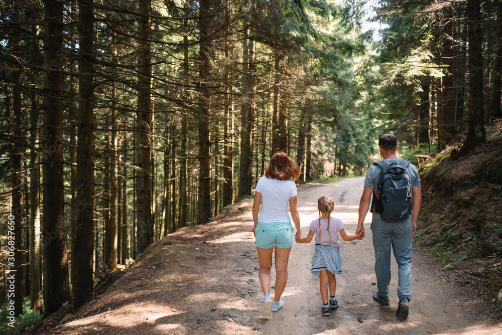 Young family with child resting on a forest Young family with child resting on a forest