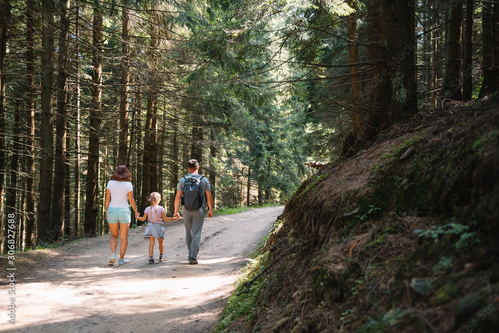 Young family with child resting on a forest Young family with child resting on a forest