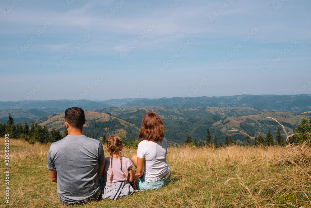 Young family with child resting on a mountain. vacation in the national park