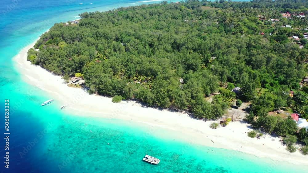 Paradise vacation location on tropical island of Bali with lush vegetation and white sandy beach washed by beautiful blue turquoise lagoon Paradise vacation location on tropical island of Bali with lush vegetation and white sandy beach washed by beautiful blue turquoise lagoon