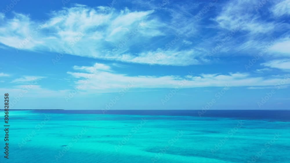 Vivid colors of seascape wallpaper with frozen clouds on bright blue sky over ocean horizon and shiny turquoise lagoon in Antigua, copy space Vivid colors of seascape wallpaper with frozen clouds on bright blue sky over ocean horizon and shiny turquoise lagoon in Antigua, copy space