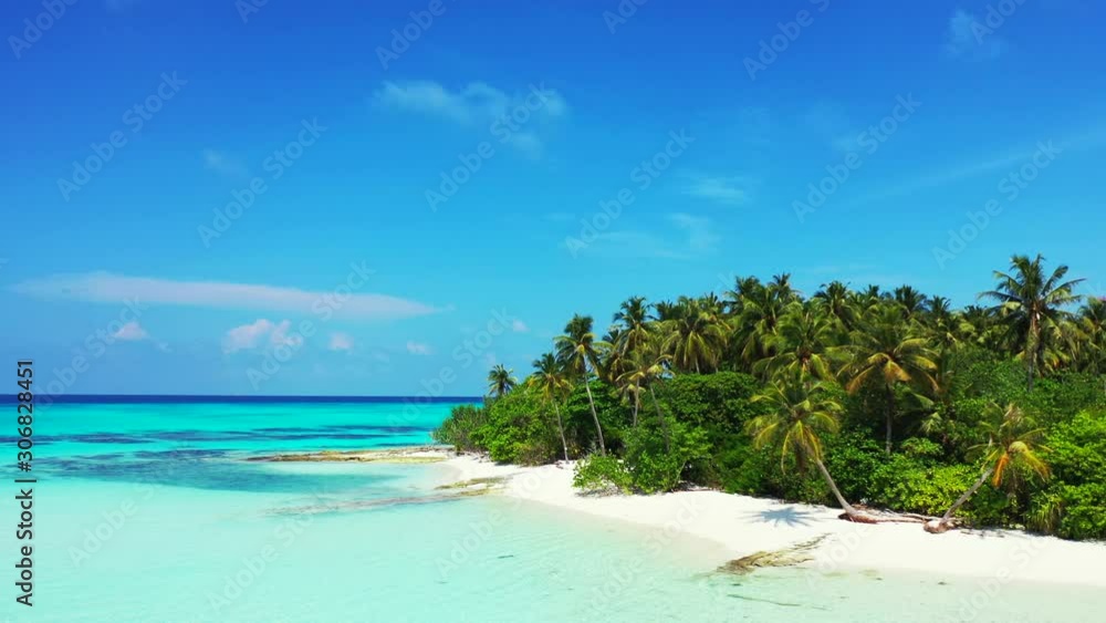 Paradise tropical island with palm trees bent over white sand of exotic beach washed by calm clear water of turquoise lagoon on a bright sky in Dominican Republic Paradise tropical island with palm trees bent over white sand of exotic beach washed by calm clear water of turquoise lagoon on a bright sky in Dominican Republic