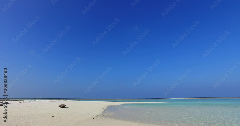 Clear bright blue sky of morning over untouched white sandy beach washed by turquoise sea lagoon with calm water in Antigua Clear bright blue sky of morning over untouched white sandy beach washed by turquoise sea lagoon with calm water in Antigua