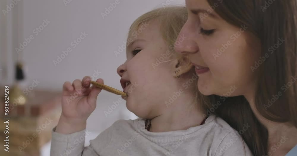 Close-up faces of happy Caucasian mother and daughter having fun. Young brunette woman and little blond girl laughing. Mom taking care of child. Happiness, leisure, positivity. Cinema 4k ProRes HQ. Close-up faces of happy Caucasian mother and daughter having fun. Young brunette woman and little blond girl laughing. Mom taking care of child. Happiness, leisure, positivity. Cinema 4k ProRes HQ.