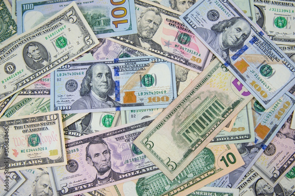 Money american hundred dollar bills Pile of various currencies isolated on white background.Closeup of assorted American banknotes.US currency scattered on the table.america currency dollor currency.