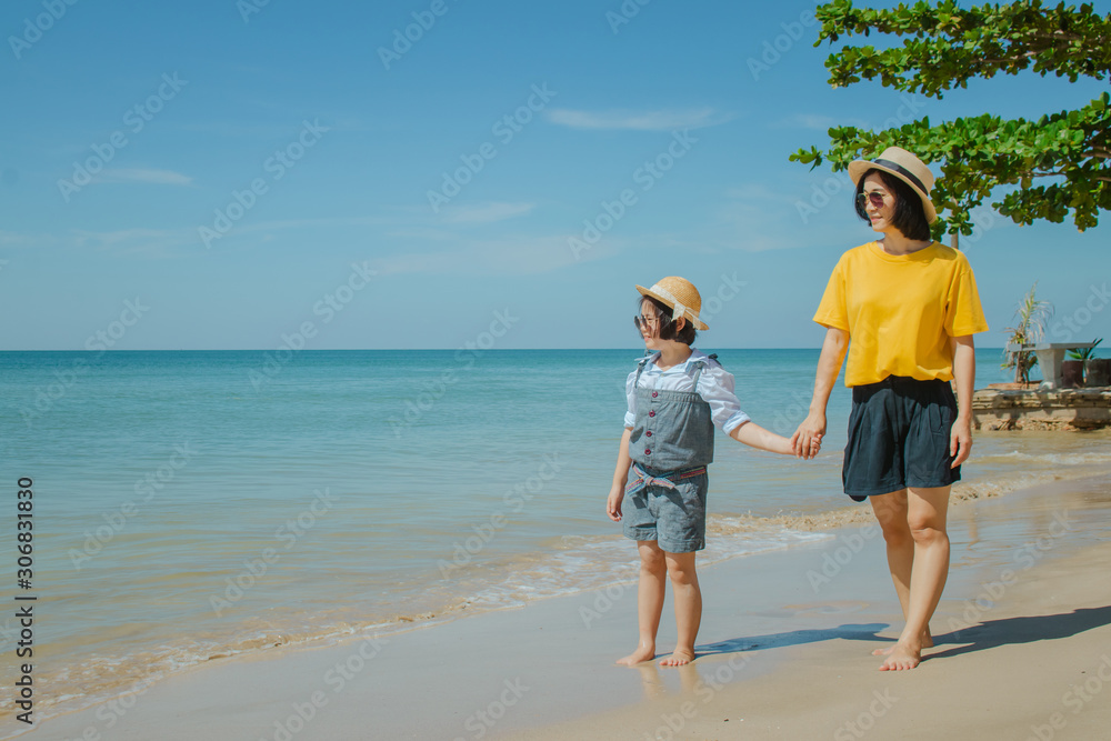 Summer Vacation and Happy Family Concept : Woman and child walking on sand beach and they felling happiness. Summer Vacation and Happy Family Concept : Woman and child walking on sand beach and they felling happiness.