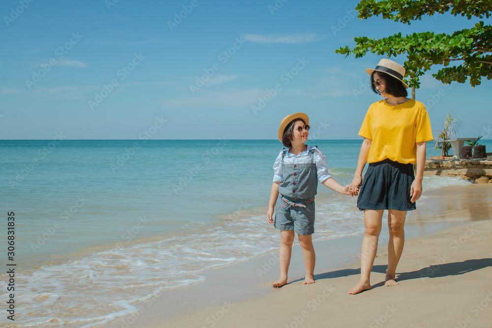 Summer Vacation and Happy Family Concept : Woman and child walking on sand beach and they felling happiness. Summer Vacation and Happy Family Concept : Woman and child walking on sand beach and they felling happiness.