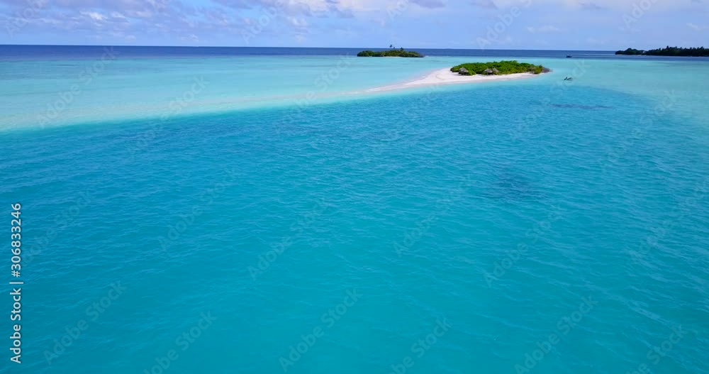 Tranquil azure water in the middle of turquoise lagoon close to tiny tropical islands with lush vegetation on a bright sky background in Caribbean Tranquil azure water in the middle of turquoise lagoon close to tiny tropical islands with lush vegetation on a bright sky background in Caribbean