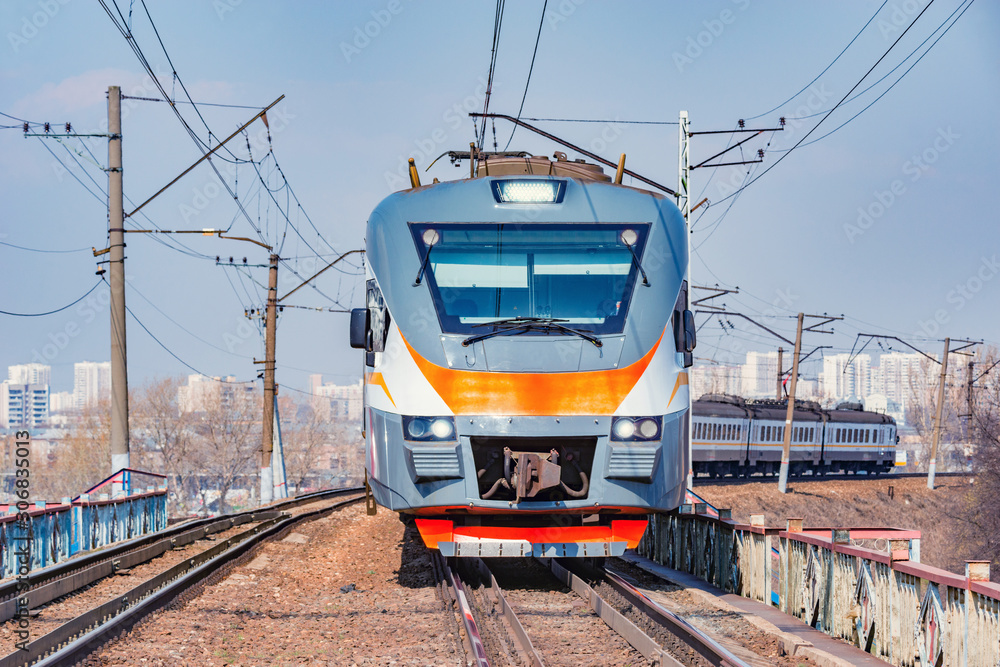 Passenger train moves on city background. Moscow. Russia. Passenger train moves on city background. Moscow. Russia.