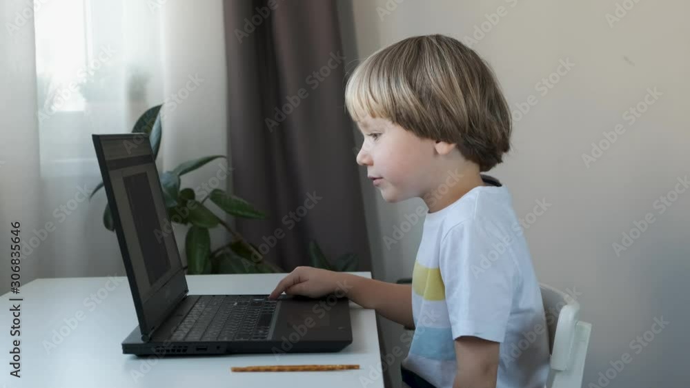 Boy working on a computer, programming, learning or playing Boy working on a computer, programming, learning or playing
