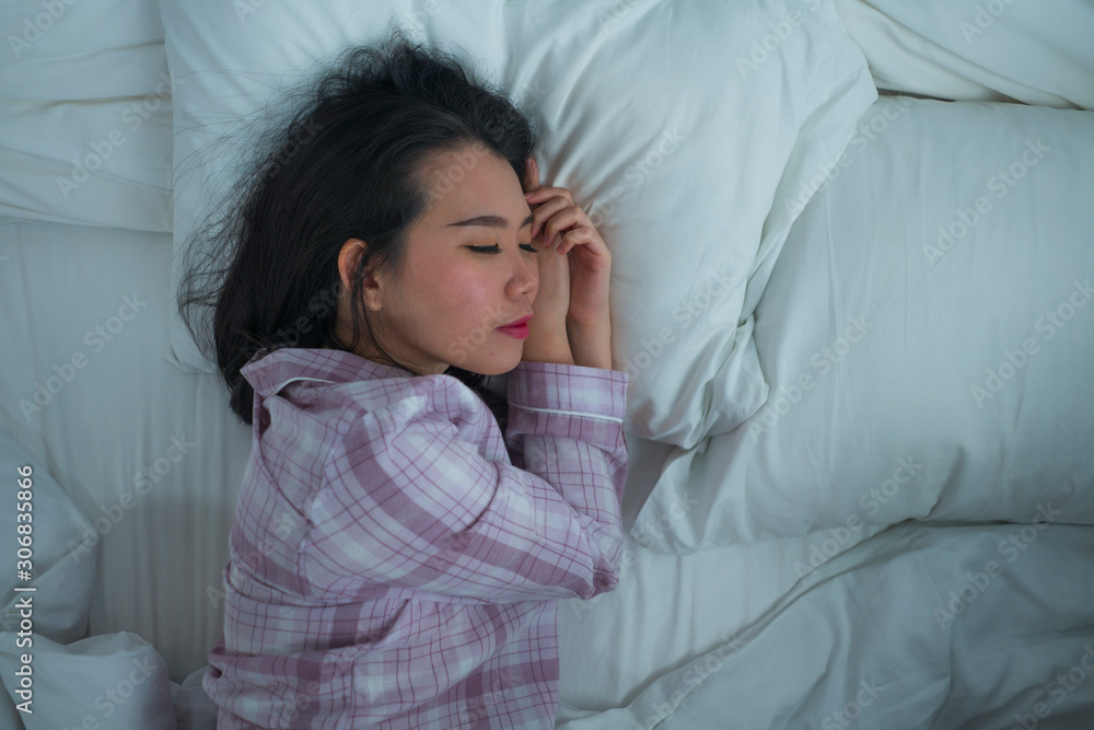 lifestyle portrait of young beautiful and sweet Asian Korean girl on her 20s alone at home sleeping relaxed wearing pajamas lying on bed happy and comfortable resting lifestyle portrait of young beautiful and sweet Asian Korean girl on her 20s alone at home sleeping relaxed wearing pajamas lying on bed happy and comfortable resting