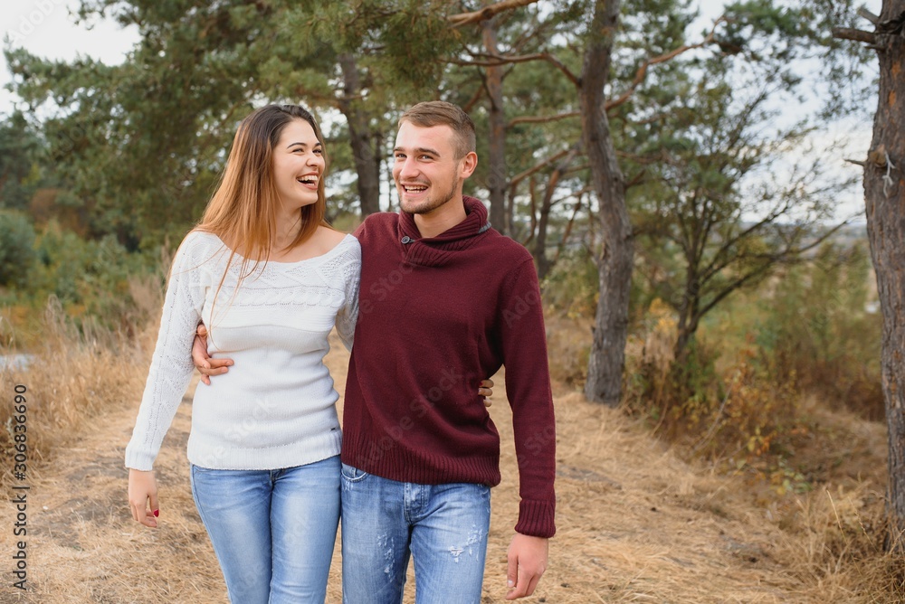 low contrast image of a happy romantic young couple spending time outdoor in the autumn park low contrast image of a happy romantic young couple spending time outdoor in the autumn park