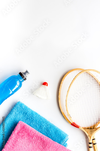 Tennis equipment - rockets, shuttlecock - on white background top-down frame copy space