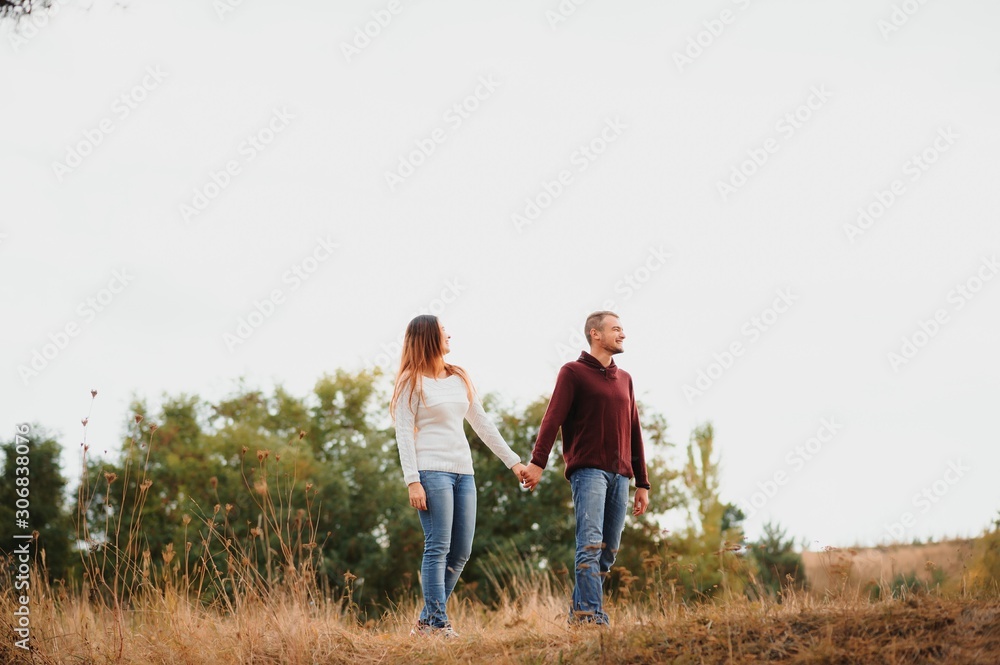 low contrast image of a happy romantic young couple spending time outdoor in the autumn park low contrast image of a happy romantic young couple spending time outdoor in the autumn park