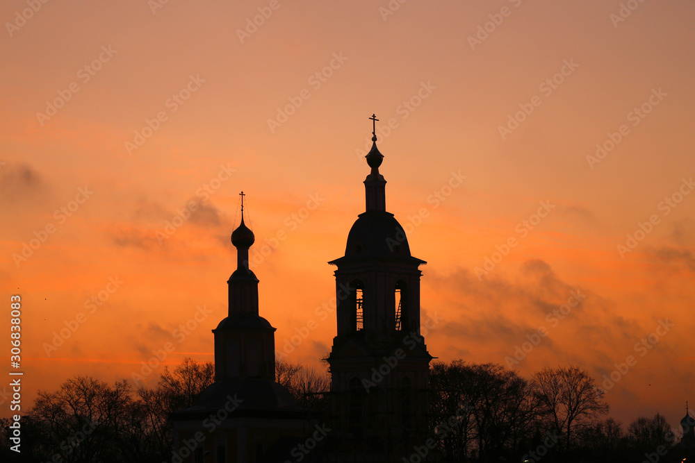 Bright photo dawn with clouds with a Church