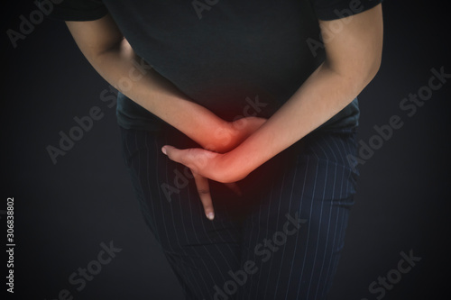 Woman with hands holding pressing crotch lower abdomen,female patient having painful suffering from stomachache 