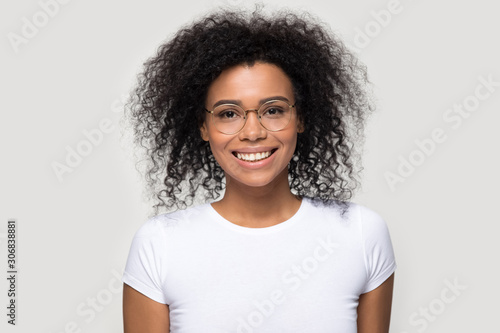 Head shot portrait smiling African American woman wearing glasses