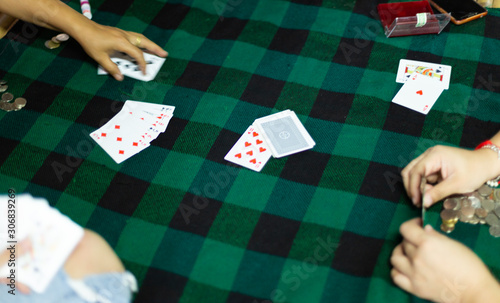 People playing card and paying coin 