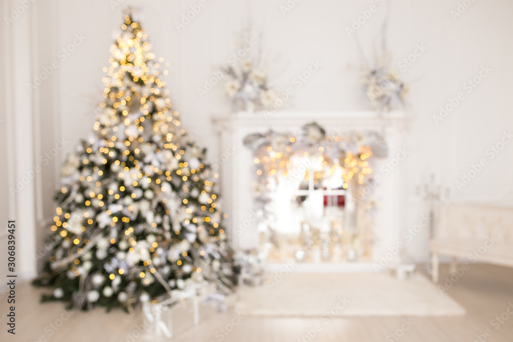 Blurred card with christmas tree and fireplace in a white room.