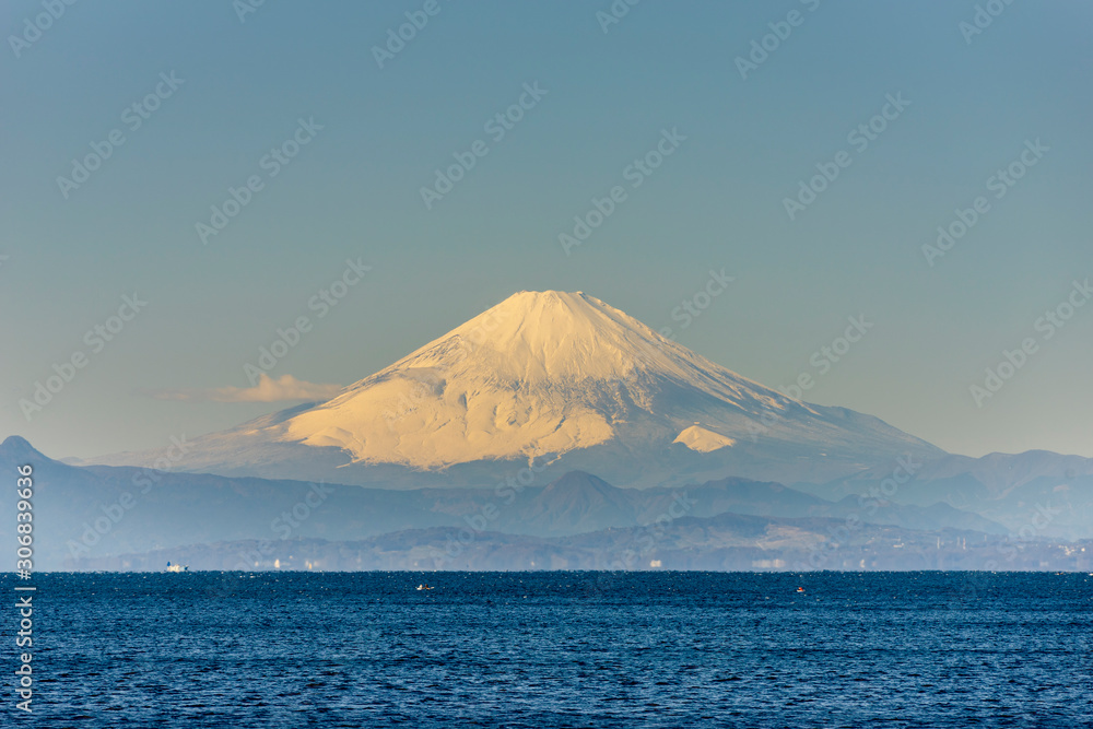 雪をかぶった富士山を相模湾岸に望む