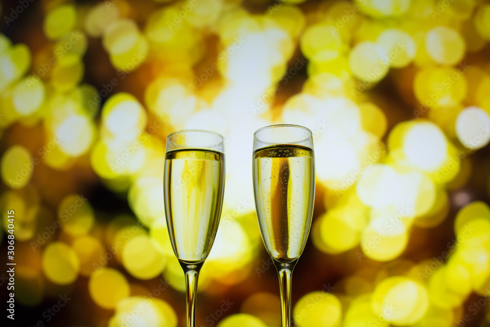 Two glasses of champagne on a bokeh background. Close-up isolated background. Two glasses of champagne on a bokeh background. Close-up isolated background.