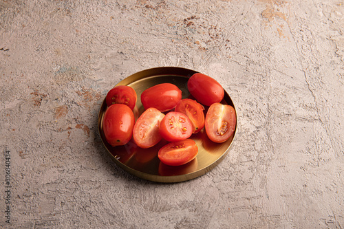 tomatoes on golden plate top view horizontal