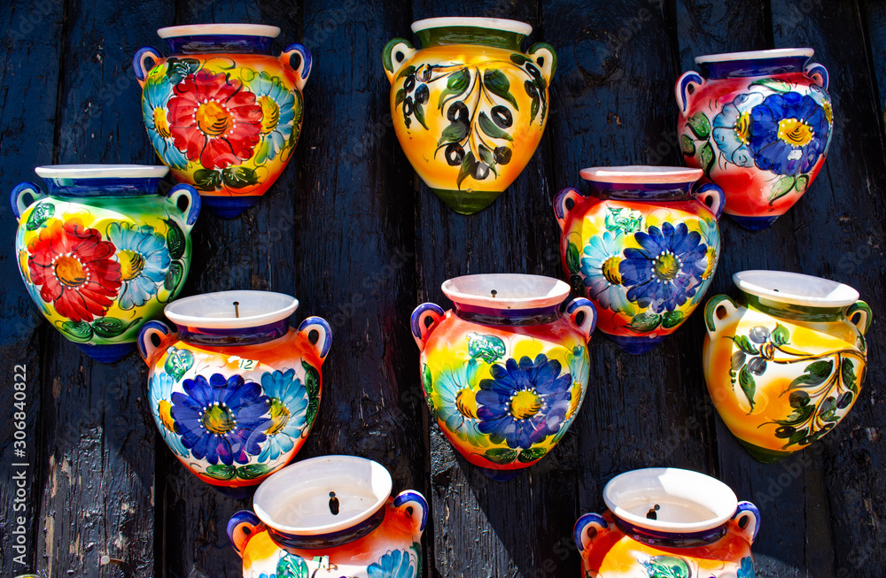 Brightly multicoloured pots for hanging plants, decoration and flowers.