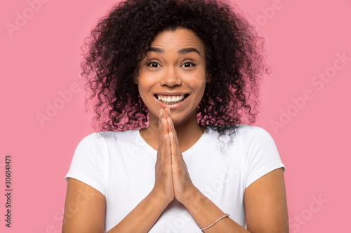 Happy African American woman joining hands with excitement