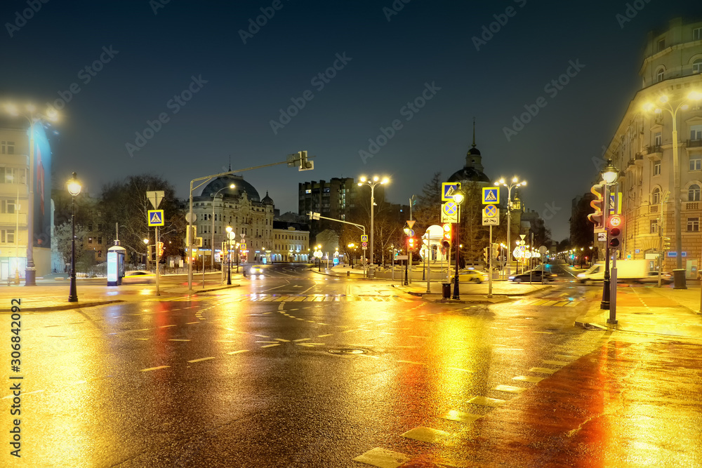 moscow city winter street at night in historic city center landmark against dark sky background. Street landscape view of downtown of russian capital with sparse car traffic and beautiful city lights