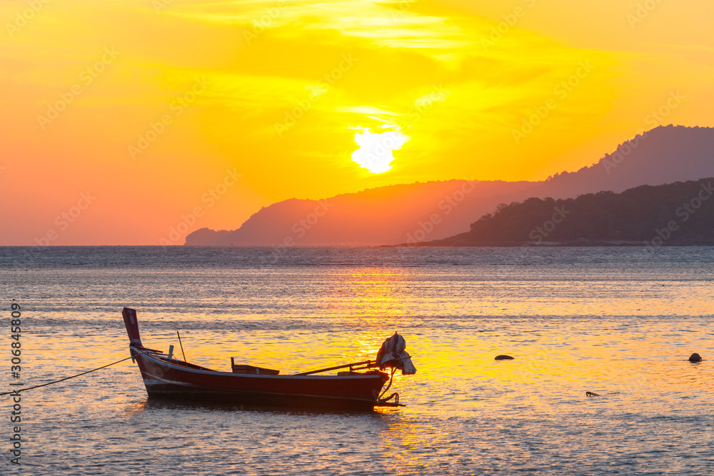 beautiful golden sunrise above fishing boats in Rawai sea Phuket Thailand.