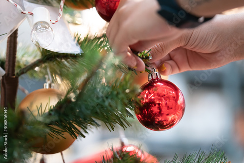 Close up of woman decorating tree for christmas