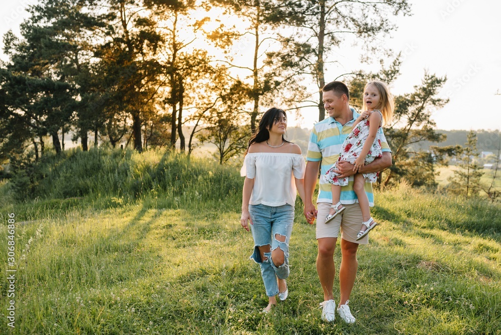 happy family concept - father, mother and child daughter having fun and playing in nature. happy family concept - father, mother and child daughter having fun and playing in nature.