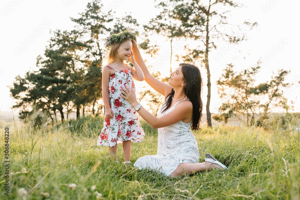 Stylish mother and handsome daughter having fun on the nature. Happy family concept. Beauty nature scene with family outdoor lifestyle. family resting together. Happiness in family life. Mothers day Stylish mother and handsome daughter having fun on the nature. Happy family concept. Beauty nature scene with family outdoor lifestyle. family resting together. Happiness in family life. Mothers day