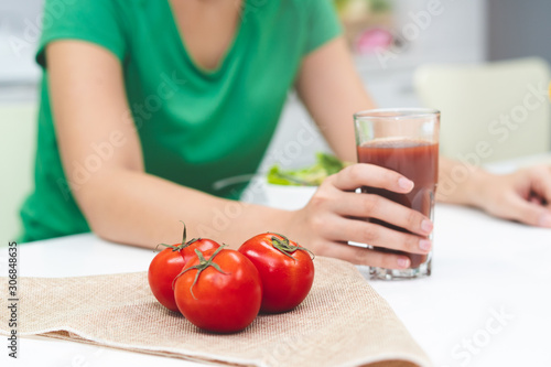 Low calories drink for wellness. woman making homemade drink by extracting fresh tomato juice.