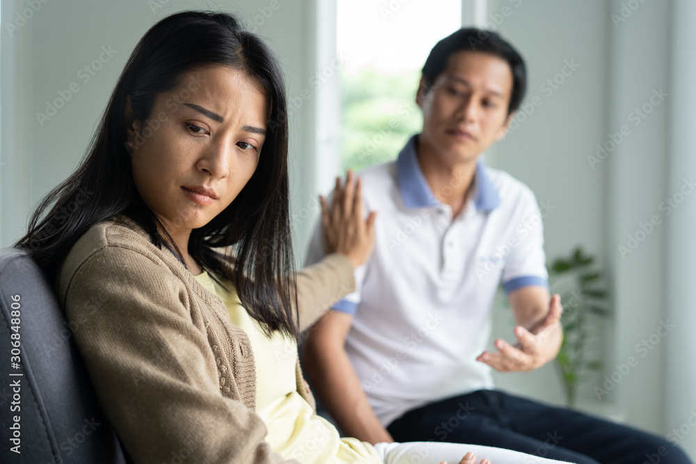 Asian couple having relation problem. Sadness wife stop husband to talk to her at home after quarrel. Asian couple having relation problem. Sadness wife stop husband to talk to her at home after quarrel.