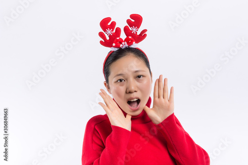 Happy Smiling Hipster Girl in knitted red sweater and hat having fun . Cute girl in glusses with piercing in the nose. Winter or Autumn Warming Up Concept. Dance. Fashion. photo