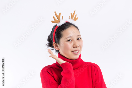 Happy Smiling Hipster Girl in knitted red sweater and hat having fun . Cute girl in glusses with piercing in the nose. Winter or Autumn Warming Up Concept. Dance. Fashion. photo