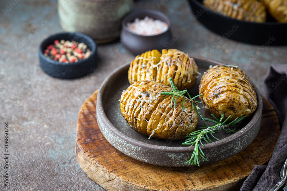 Baked hasselback potatoes with cheese, garlic and greens Baked hasselback potatoes with cheese, garlic and greens