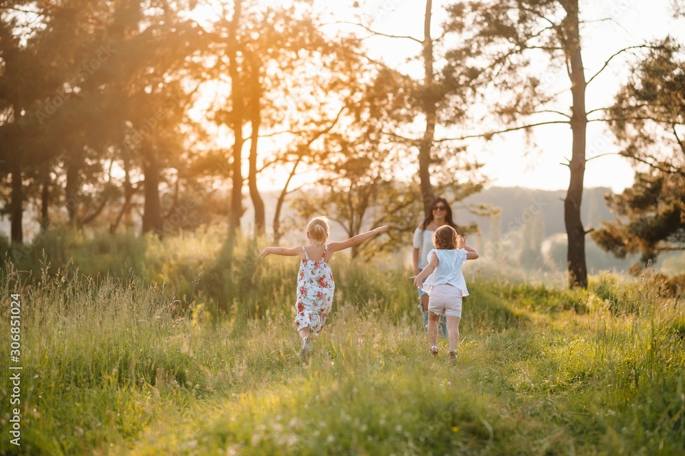 Stylish mother and handsome daughter having fun on the nature. Happy family concept. Beauty nature scene with family outdoor lifestyle. family resting together. Happiness in family life. Mothers day Stylish mother and handsome daughter having fun on the nature. Happy family concept. Beauty nature scene with family outdoor lifestyle. family resting together. Happiness in family life. Mothers day