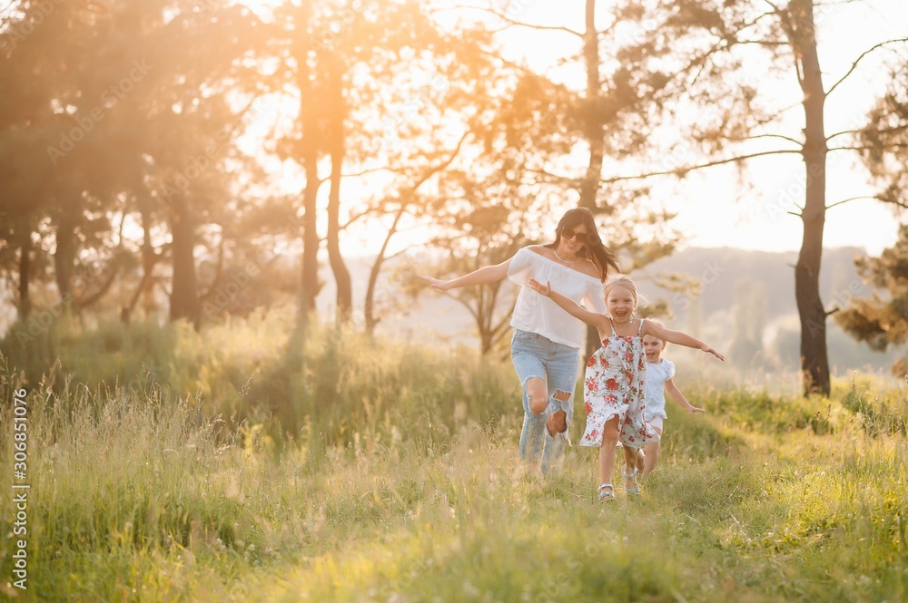 Obraz premium Stylish mother and handsome daughter having fun on the nature. Happy family concept. Beauty nature scene with family outdoor lifestyle. family resting together. Happiness in family life. Mothers day