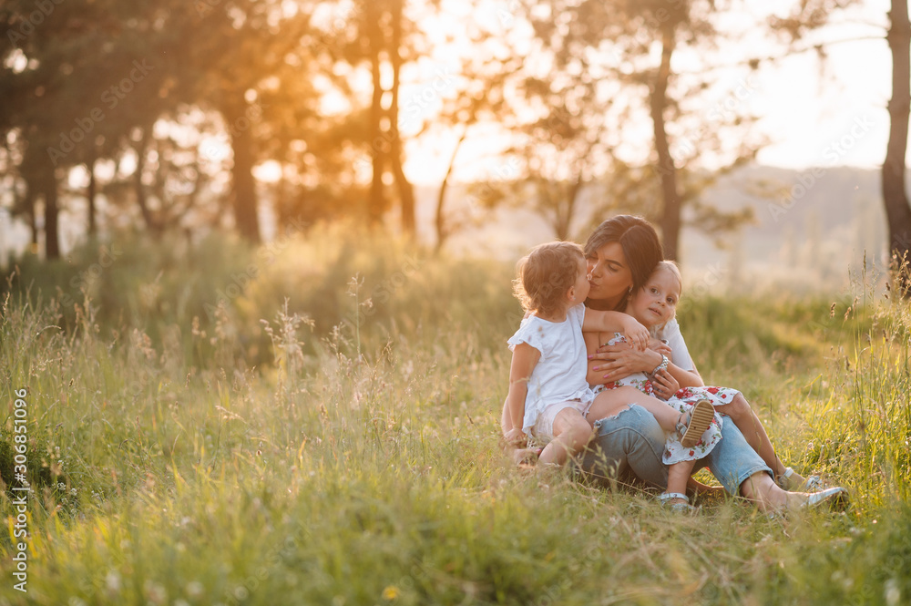 Fototapeta premium Stylish mother and handsome daughter having fun on the nature. Happy family concept. Beauty nature scene with family outdoor lifestyle. family resting together. Happiness in family life. Mothers day