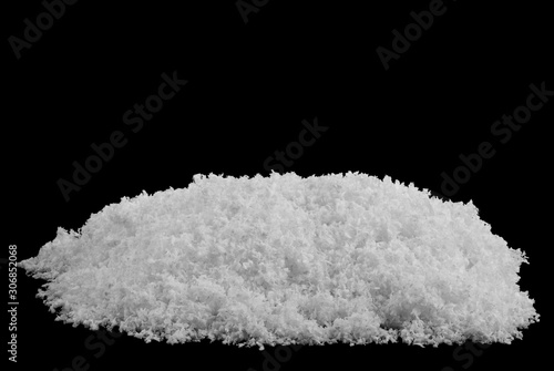 A pile of white fluffy snow isolated on a black background.