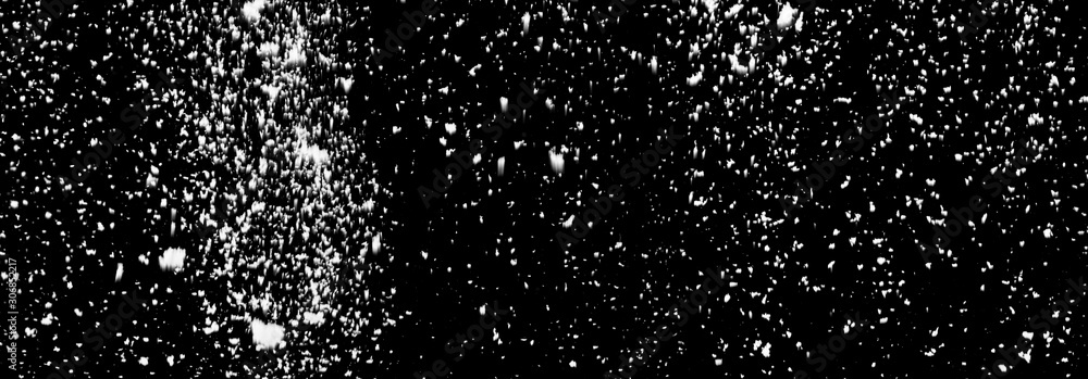 Falling white snow isolated on a black background. Falling white snow isolated on a black background.