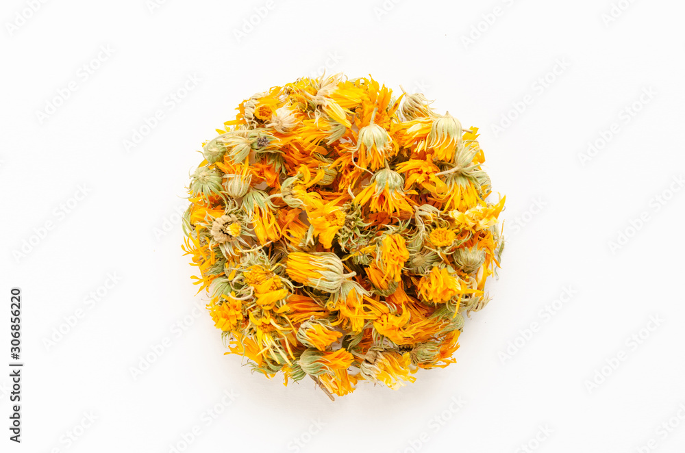 Calendula or pot marigold dried flowers on white background. Herbal medicine concept. Close-up. Top view Calendula or pot marigold dried flowers on white background. Herbal medicine concept. Close-up. Top view
