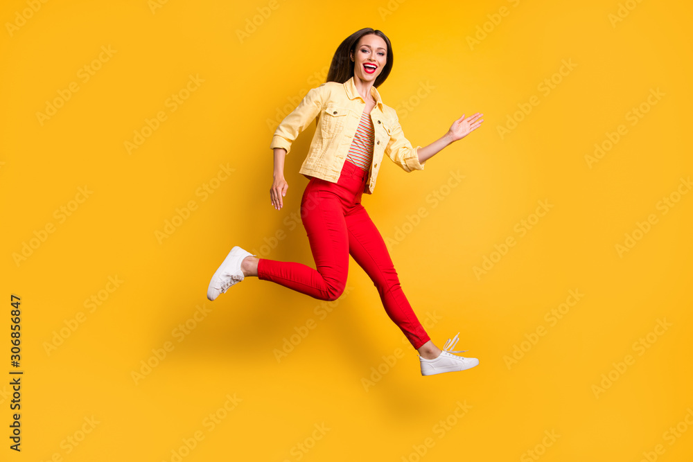 Side profile full length body size photo of cheerful pretty cute charming girl running towards shopping mall for sales in red pants isolated vivid color background Side profile full length body size photo of cheerful pretty cute charming girl running towards shopping mall for sales in red pants isolated vivid color background