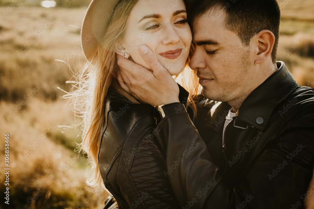 Happy young couple enjoying outdoors during sunset . Happy young couple enjoying outdoors during sunset .
