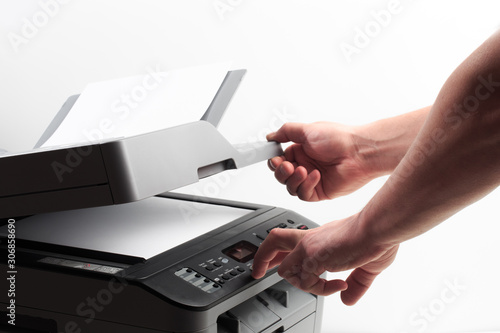 Hand press button on panel of printer. printer scanner laser office copy machine supplies start concept - Image