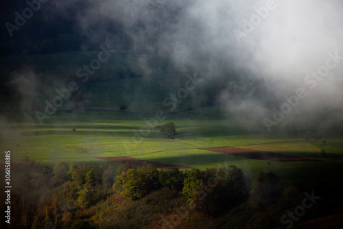 Panoramic view of a magical valley in the morning light. Fogy landscape.