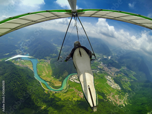 Two hang glider pilots fly above beautiful scenery of Soca valley photo